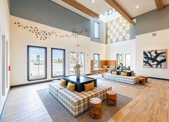 a large living room with couches and a table at Magnolia Grove Apartments, Terrell, TX