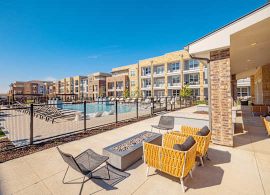 pool and patio area with chairs and tables at Magnolia Grove Apartments, Terrell, TX, 75160