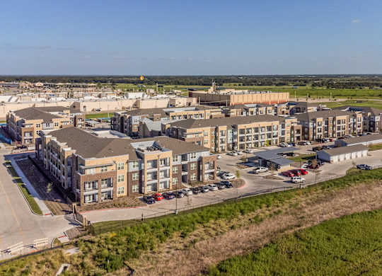an aerial view of buildings in a city at Magnolia Grove Apartments, Terrell, TX, 75160