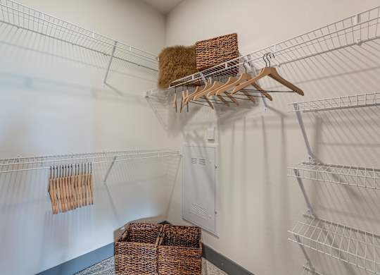 A white closet with a hanger and a basket. at Magnolia Grove Apartments, Terrell, 75160