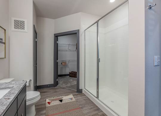 A bathroom with a toilet, sink, and shower. at Magnolia Grove Apartments, Terrell, Texas