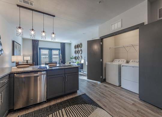 A modern kitchen with dark wood cabinets and stainless steel appliances. at Magnolia Grove Apartments, Terrell, TX, 75160