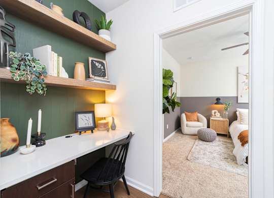 a living room with a desk and a mirror at Terraces at Town Center, Florida