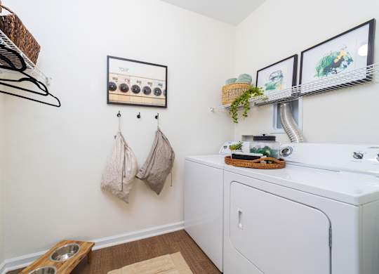 a washer and dryer in a laundry room with pictures on the wall at Terraces at Town Center, Florida
