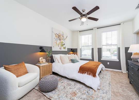 a bedroom with a large bed and a ceiling fan at Terraces at Town Center, Jacksonville
