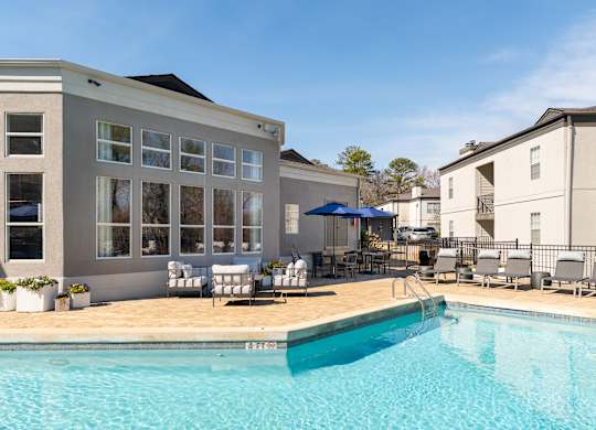 swimming pool with chairs and umbrellas at WildForest Apartments, Alabama