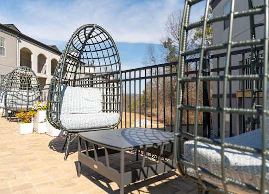 a seating area with chairs and a table on a balcony at WildForest Apartments, Birmingham, AL, 35209