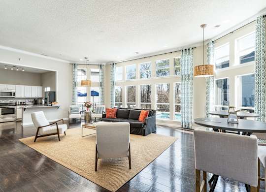 a living room with a couch and chairs and a table at WildForest Apartments, Birmingham, 35209