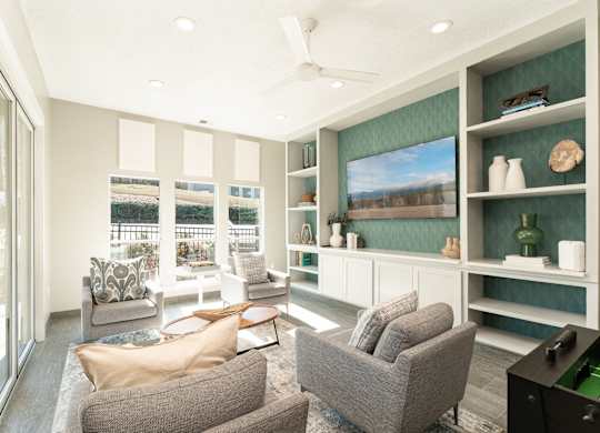 a living room with a couch and chairs and a television at WildForest Apartments, Birmingham, Alabama
