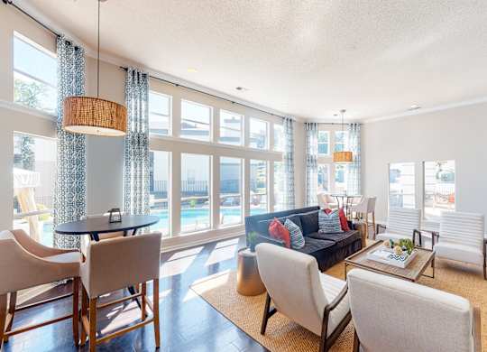 a living room with a couch and a table with chairs at WildForest Apartments, Alabama, 35209