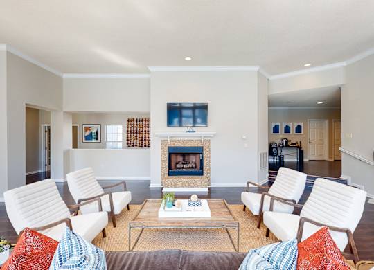 a living room with white furniture and a fireplace at WildForest Apartments, Alabama