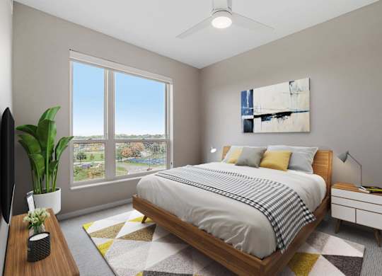 bedroom with queen bed and ample natural light at The Hallon Apartments, Hopkins, Minnesota