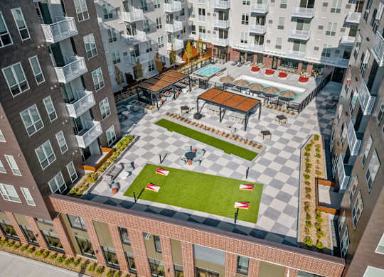an aerial view of the courtyard of an apartment building with a lawn at The Hallon Apartments, Minnesota