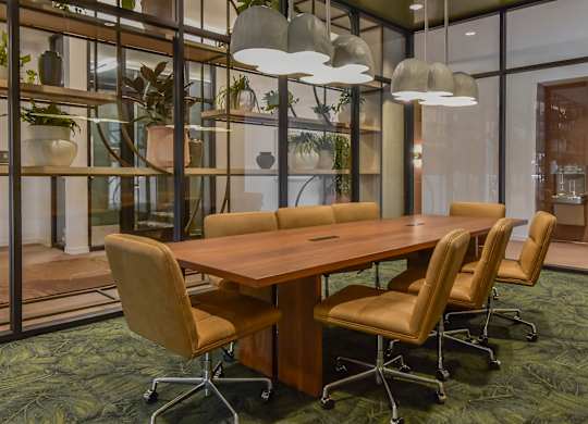 A conference room with a long table and chairs.