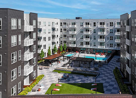 A large apartment complex with a pool and a checkerboard patterned area.