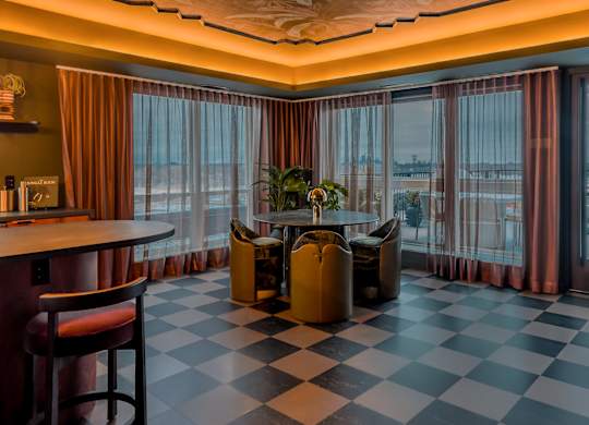 A room with a checkered floor and a bar area.