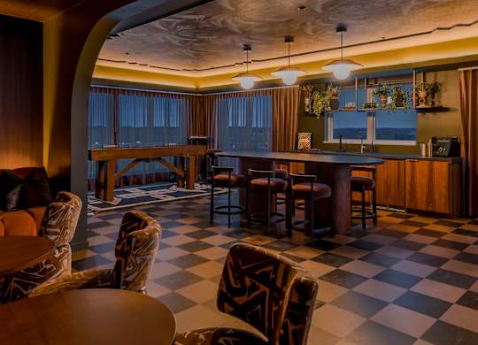 A room with a checkered floor and a bar area.