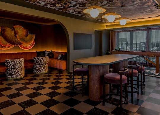 A black and white checkered floor in a room with a bar.