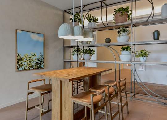A dining area with a wooden table and chairs.
