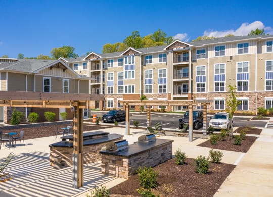 an outdoor patio with a firepit and picnic table at the enclave at woodbridge apartments in