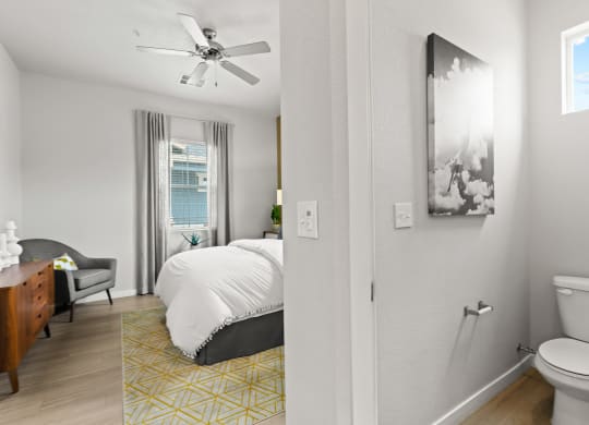 a bedroom with a bed and a ceiling fan in a 555 waverly unit