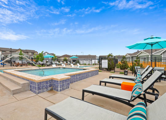 the reserve at bucklin hill pool and hot tub with lounge chairs and umbrellas