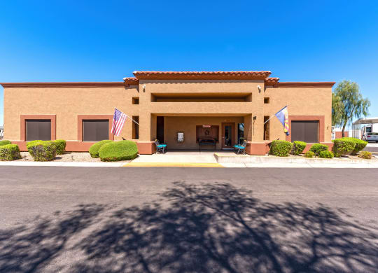 the front of a brick building flags in front of it