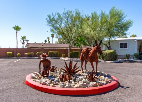 a statue of a horse and a man in a round garden