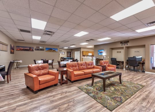 a common room with couches and chairs and a table