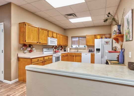 a kitchen with white appliances and wooden cabinets