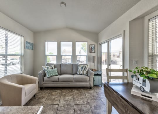 a living room with a couch and a table and a chair