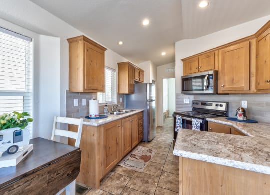 a kitchen with wooden cabinets and stainless steel appliances