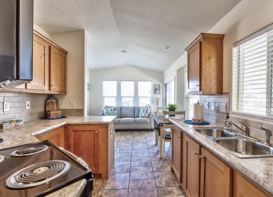 the kitchen has granite counter tops and wooden cabinets