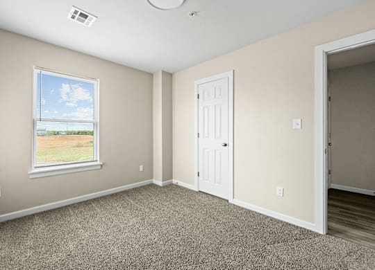 A room with a window and a door.