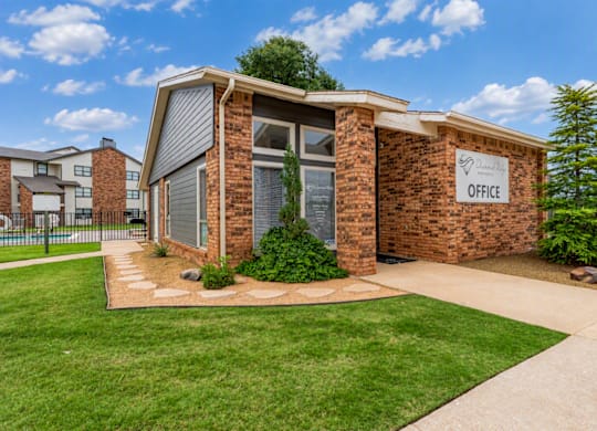A small brick building with a sign that says