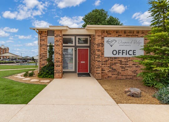 The front of a brick building with a sign that says