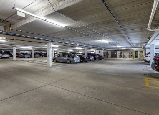 the parking garage is filled with parked cars