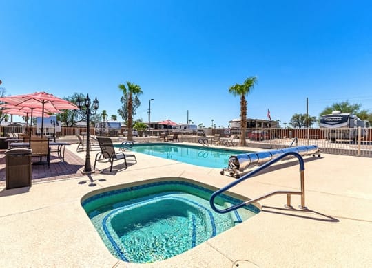 our resort style swimming pool is open to the community and has tables and chairs around