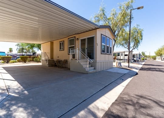 a mobile home is parked on the side of a driveway