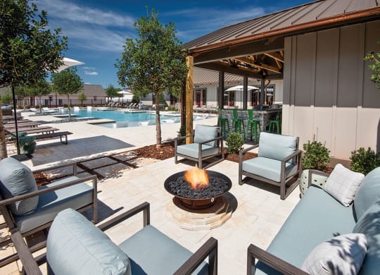 fire pit with seating on the pool deck