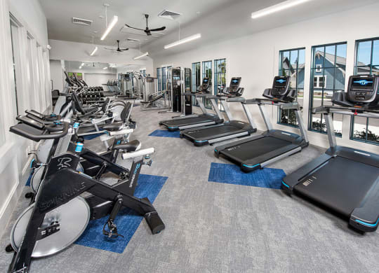 fitness center with bikes and treadmills