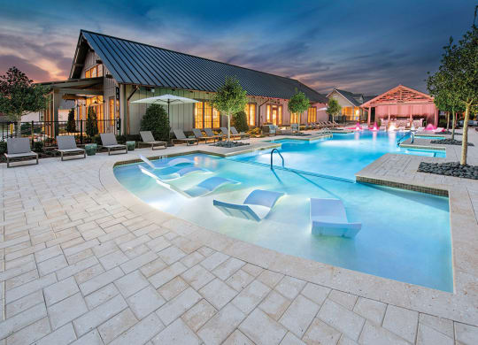 night view of pool with seating