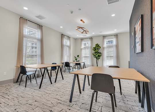A conference room with a long table and chairs.