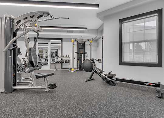 A gym with a variety of equipment including a leg press machine.