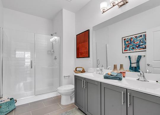 A bathroom with a toilet, sink, and shower.