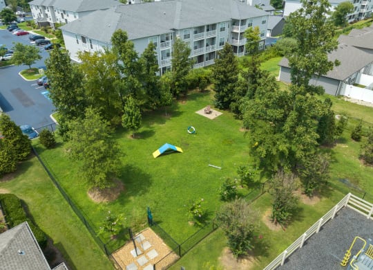 an aerial view of a backyard with a trampoline