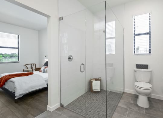 a bedroom with a bed and a toilet in a room