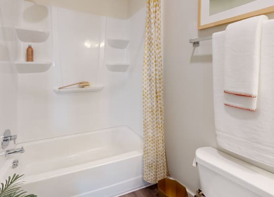 a bathroom with a shower and a sink and a tub