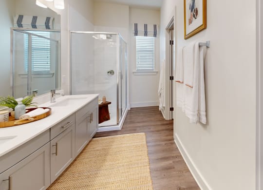 a bathroom with a shower and a sink and a mirror