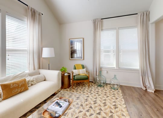 a living room with a white couch and a rug